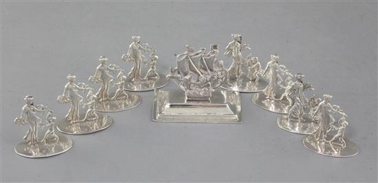 A set of eight Edwardian silver figural menu holders, depicting Venus and Cupid,